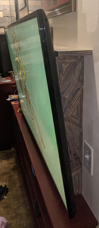 Behind TV shelf