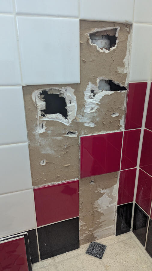Broken main floor wall and tile